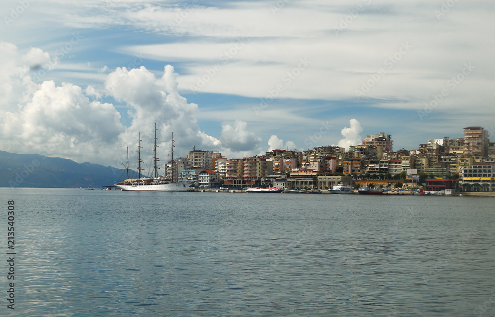 Saranda city port at ionian sea. Albania. Sarande. Beautuful view, white ship, yacht, sea, clouds in the sky.