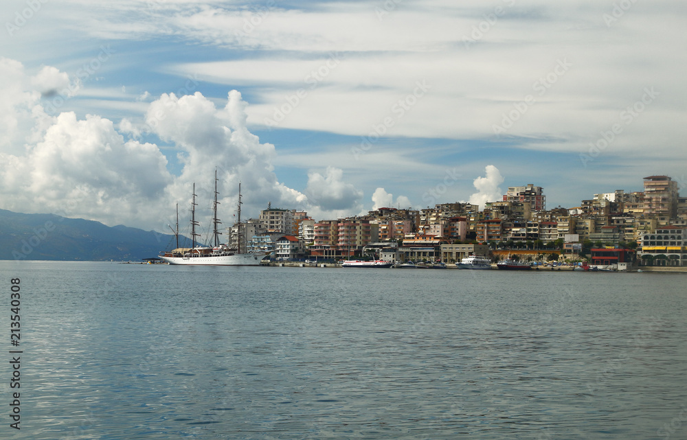 Saranda city port at ionian sea. Albania. Sarande. Beautuful view, white ship, yacht, sea, clouds in the sky. Saranda city port at ionian sea. Albania. Sarande. Beautuful view, white ship, yacht, sea, clouds in the sky.