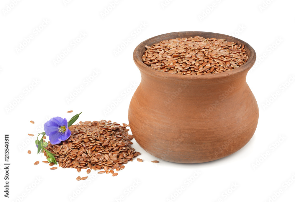 clay pot with flax seeds and flower isolated on white background. flaxseed or linseed. Cereals. clay pot with flax seeds and flower isolated on white background. flaxseed or linseed. Cereals.