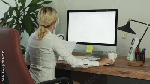 Young Business Woman Using a Computer Checking Data
