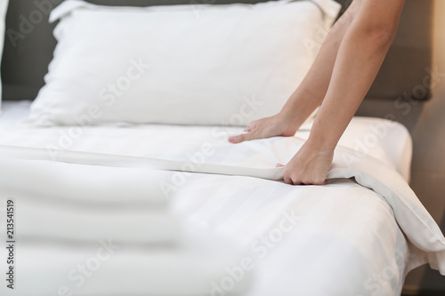 Hands Making Bed from Hotel Room Service