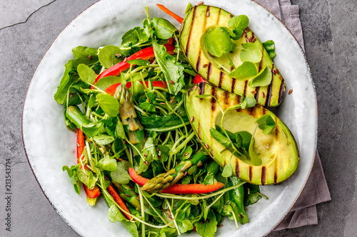 Green salad with grilled avicado. Top view photo