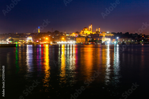 Night view of Istanbul. Panorama cityscape of famous tourist destination Golden Horn bay part of Bosphorus strait. Travel illuminated landscape Bosporus, Turkey, Europe and Asia.