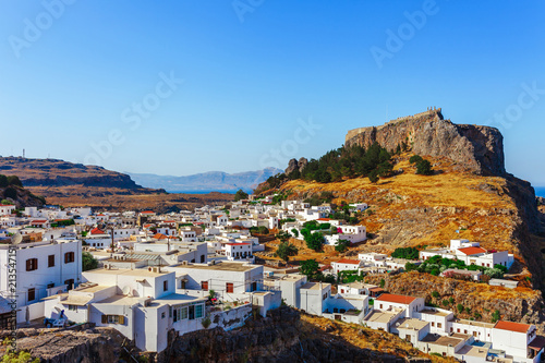 Skyview landscape photo Lindos town and ancient castle on Rhodes island, Dodecanese, Greece. Panorama with mountains and sea. Famous tourist destination in South Europe © oleg_p_100