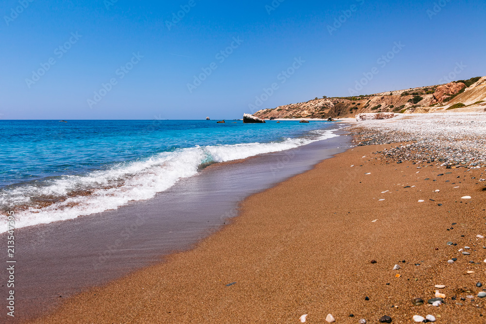 Beautiful beach on Petra tou Romiou (The rock of the Greek), Aphrodite's legendary birthplace in Paphos, Cyprus island, Mediterranean Sea. Amazing blue green sea and sunny day.