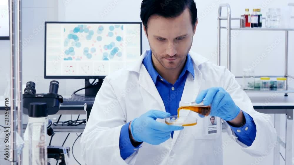 Scientists or chemists drop liquid to glass and looking to reaction. Team Scientists working in a laboratory together. 4K Resolution.