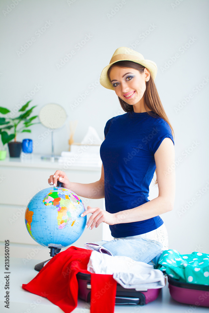 Vacation. Woman Who is Preparing for Rest. Young Beautiful Girl Sits on the Bed. Portrait of a Smiling Woman. Happy Girl Goes On Vacation Vacation. Woman Who is Preparing for Rest. Young Beautiful Girl Sits on the Bed. Portrait of a Smiling Woman. Happy Girl Goes On Vacation