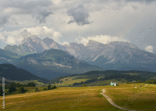 Sassolungo mountains on the Italian Alps Dolomites and a rainbow