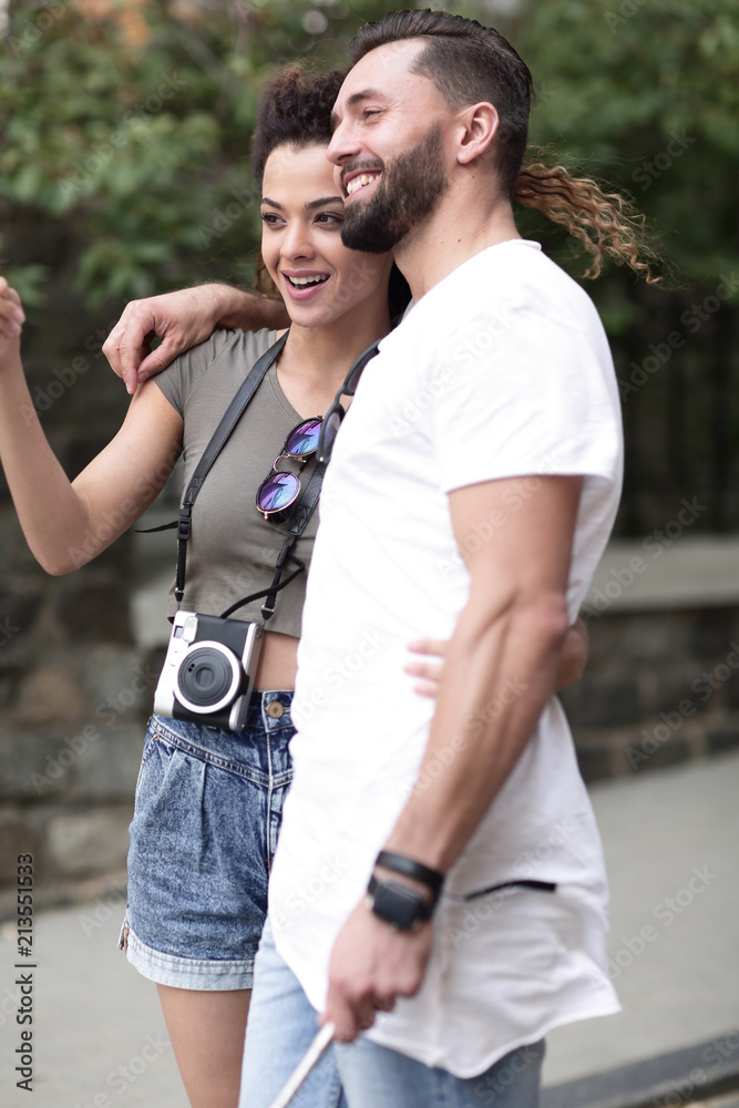 Cheerful young couple walking on urban street Cheerful young couple walking on urban street