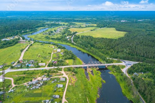 Bird's eye view of the green forests, river and the village. Karelia, Russia.