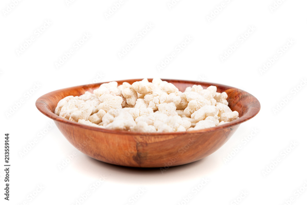 Piles of pale whole grain children's puffed cereal snack Piles of pale whole grain children's puffed cereal snack