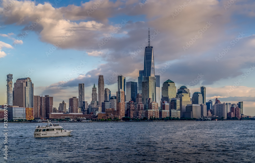 Panorama view of  NYC Lower Manhattan skyline with cruise ship passing by on Hudson River.