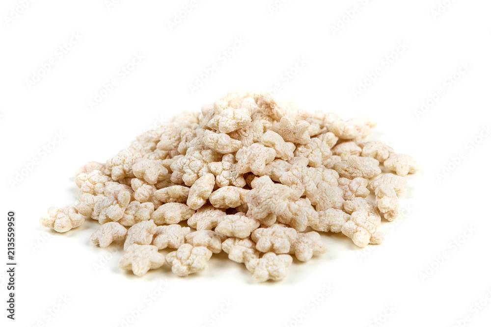 Piles of pale whole grain children's puffed cereal snack Piles of pale whole grain children's puffed cereal snack