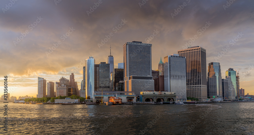 Panorama view of  NYC Lower Manhattan skyline with sailboat passing by in New York Harbor