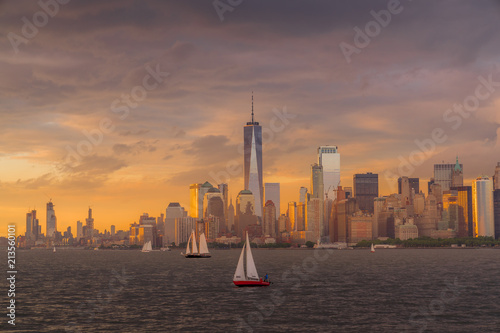 Panorama view of  NYC Lower Manhattan skyline with sailboats passing by in New York Harbor photo