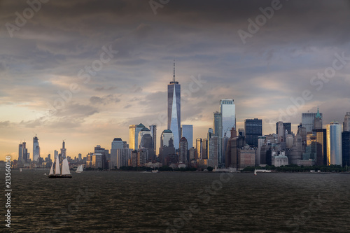 Panorama view of  NYC Lower Manhattan skyline with sailboats passing by in New York Harbor