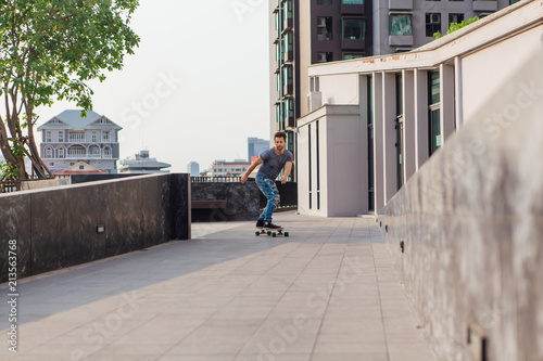 Young man riding skateboard on the street. © Smile