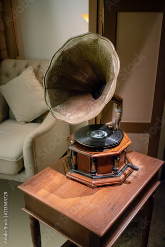 Antique classic retro gramophone on wooden table. Music box. Vintage interior concept.