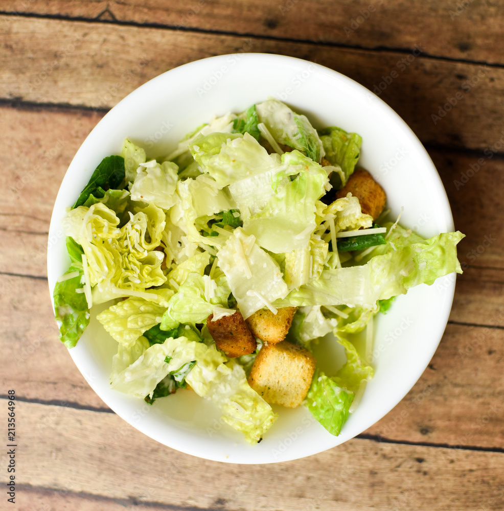 Caesar salad without chicken in a circular white bowl Caesar salad without chicken in a circular white bowl