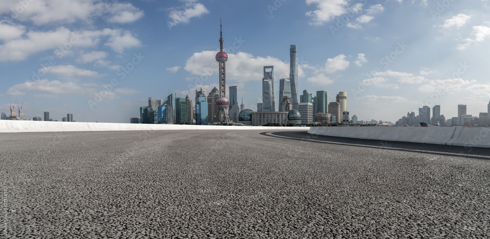 The empty asphalt road is built along modern commercial buildings in China's cities. The empty asphalt road is built along modern commercial buildings in China's cities.