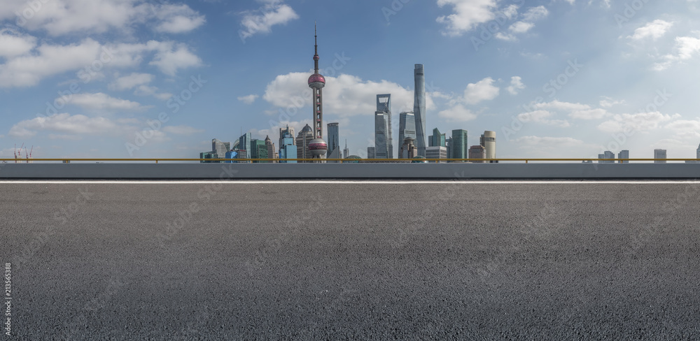 The empty asphalt road is built along modern commercial buildings in China's cities. The empty asphalt road is built along modern commercial buildings in China's cities.