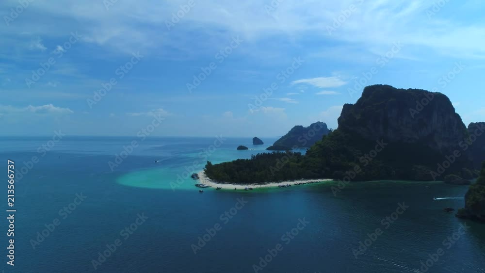 Flying around Poda Island at Krabi region in thailand. Beutiful exotic paradise island with palms and colorful water in the ocean. Perfekt for travel advertise videos - aerial drone shot Flying around Poda Island at Krabi region in thailand. Beutiful exotic paradise island with palms and colorful water in the ocean. Perfekt for travel advertise videos - aerial drone shot