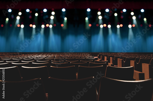 empty vintage seat in auditorium or theater with lights on stage. photo