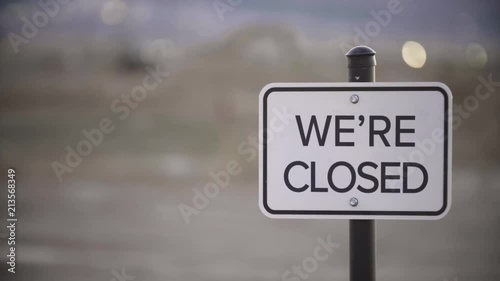 Whip pan shot of we're closed sign with blurred background photo