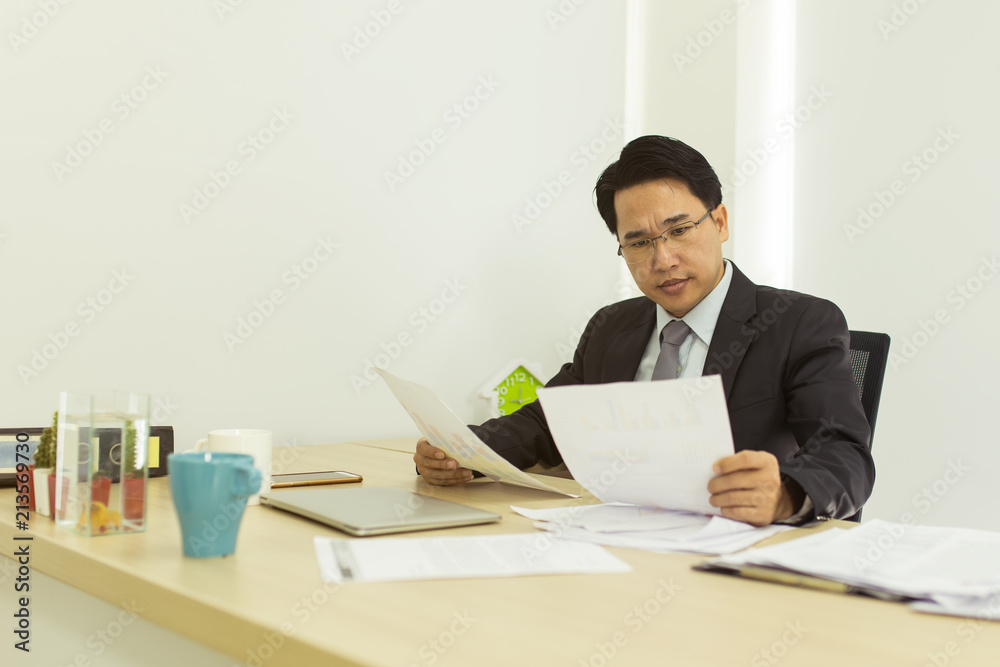 Stress businessman working at his office desk.