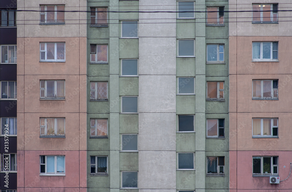 The wall of the apartment house is painted in different colors
