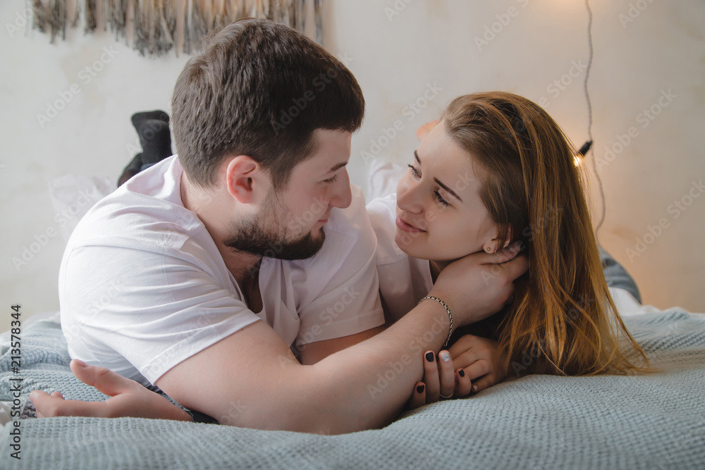 Lovely couple have fun, rest and relax on the bed together Lovely couple have fun, rest and relax on the bed together