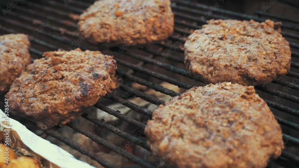 Hamburger patties cooking on the hot grill. Hamburger patties cooking on the hot grill.