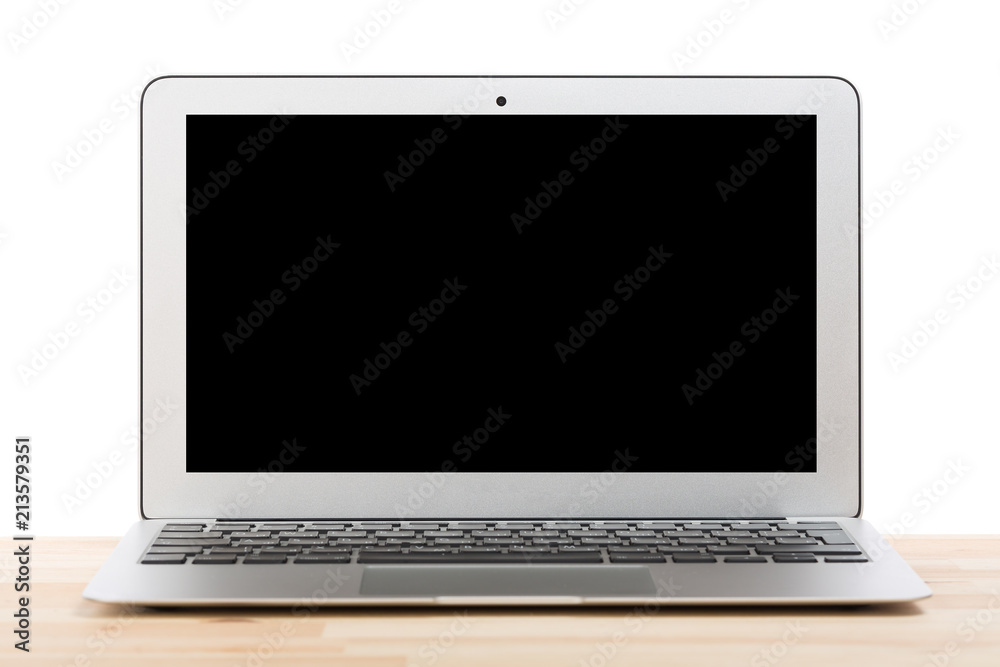 Fototapeta premium Conceptual workspace or business concept. Laptop computer with blank black screen on light wooden table. Isolated background.