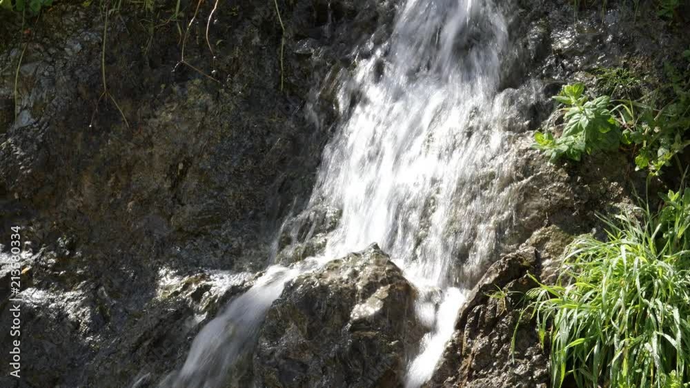 Close up of a natural waterfall splashing down on rocks Close up of a natural waterfall splashing down on rocks