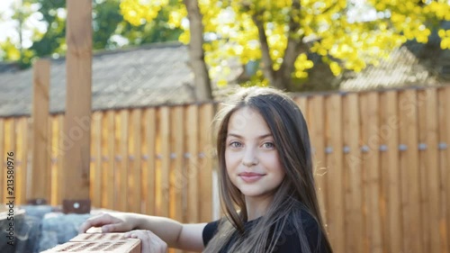 The young girl comes to rosturm, looks on arena and smiles at camera photo