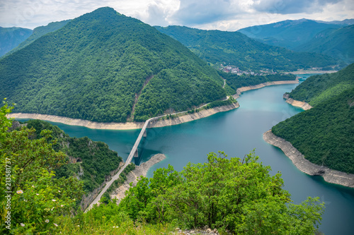 A picturesque turquoise lake can be seen from the top of a high mountain. photo