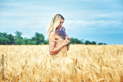 Young romantic woman in a wheat field