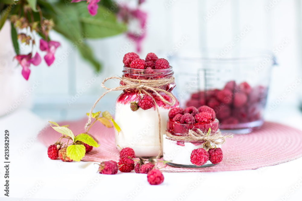 breakfasts, desserts. Yogurt with raspberry syrup and raspberry berries breakfasts, desserts. Yogurt with raspberry syrup and raspberry berries