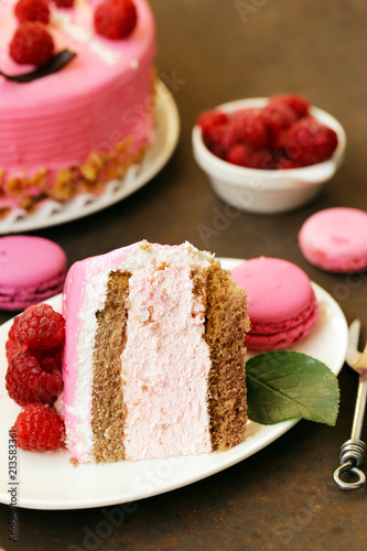 amazing pink cake with raspberries on an iron table
