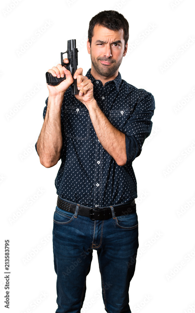 Brunette man shooting with a pistol on isolated white background Brunette man shooting with a pistol on isolated white background