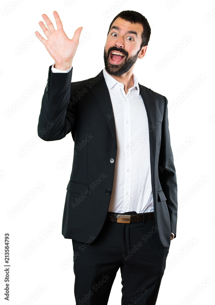 Handsome businessman saluting