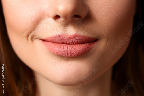 Smiling female closed red lips closeup photo