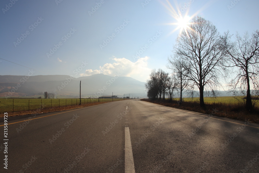 Fototapeta premium Long road through the countryside