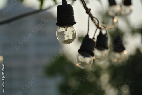 Light bulb hang on wire decoration outdoor background daylight 