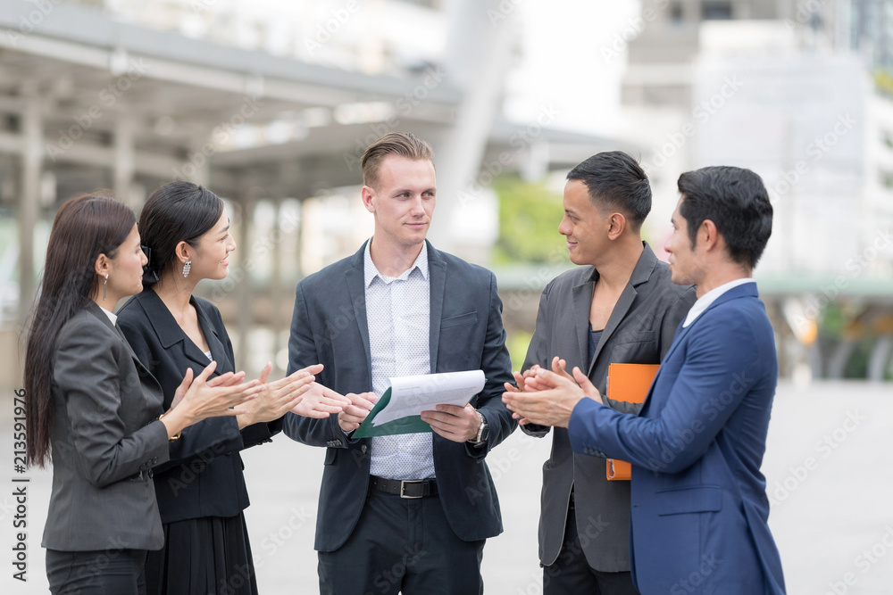 Obraz premium Confident and Active Businesspersons Creative Business Meeting Outdoor.Boss Business Woman pointing Forefinger Up.Startup Running The New Project Plan.Dealing, Merger and Acquisition Concepts.