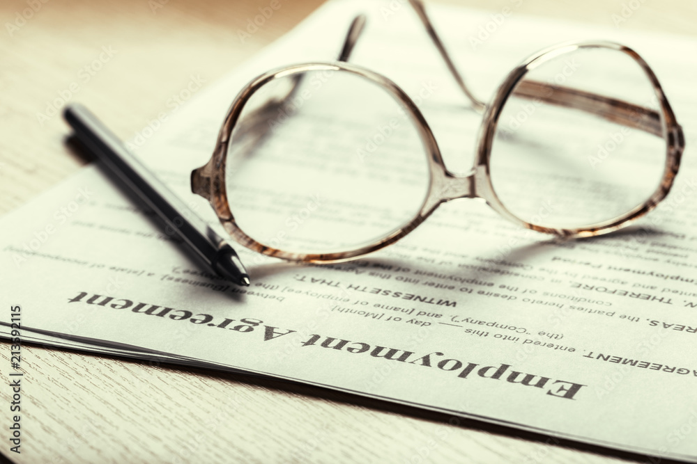 Close up shot of Eyeglasses on contract document papers business concept Close up shot of Eyeglasses on contract document papers business concept