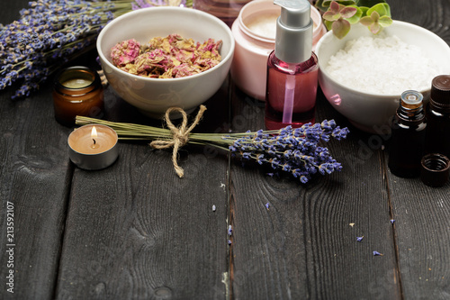 Fototapeta Naklejka Na Ścianę i Meble -  Aromatic composition of lavender, herbs, cosmetics and salt on a dark table top