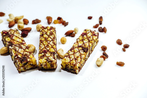 Granola bar. healthy sweet dessert snack. ?ereal granola bar with nuts, fruit and berries on white table. top view. photo