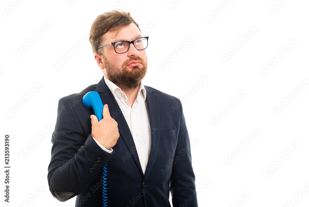 Portrait of business man holding blue receiver and thinking. Portrait of business man holding blue receiver and thinking.