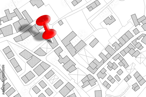 Imaginary cadastral map of territory with buildings, roads and land parcel - concept image with a red pushpin on it photo